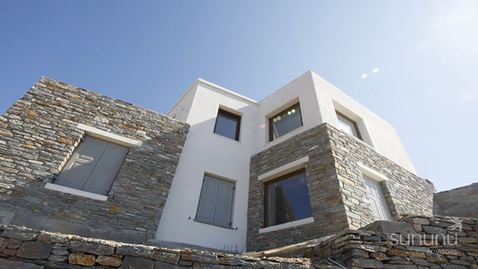 Stone clad exterior of charming villa in Kea