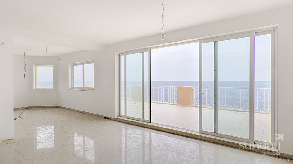 Living area of penthouse in Sliema extends to its seafront terrace